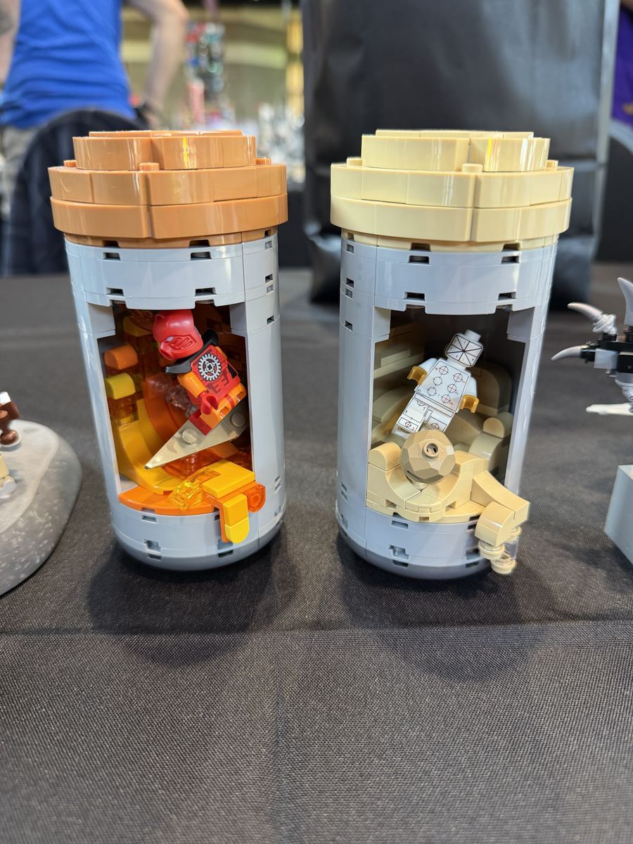 Two minifigure display capsules built from LEGO bricks